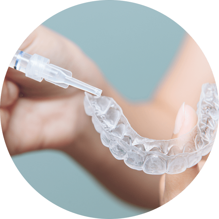dental patient using teeth whitening tray