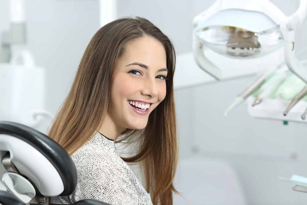 a patient smiling after her professional teeth whitening